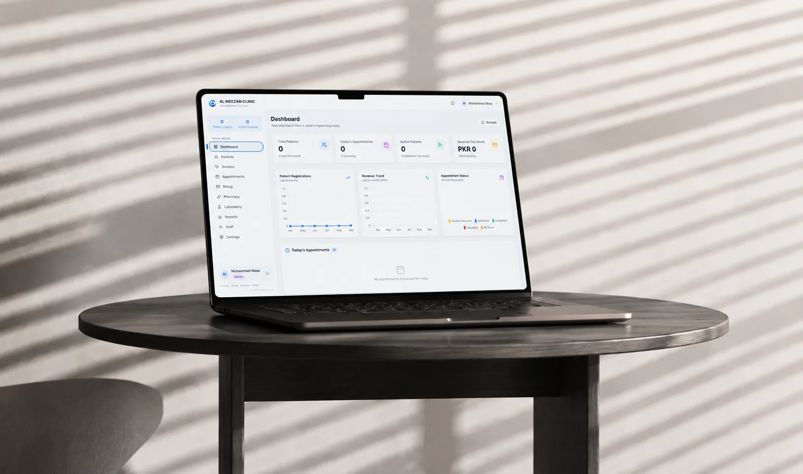 Al Meezan Clinic management dashboard on laptop