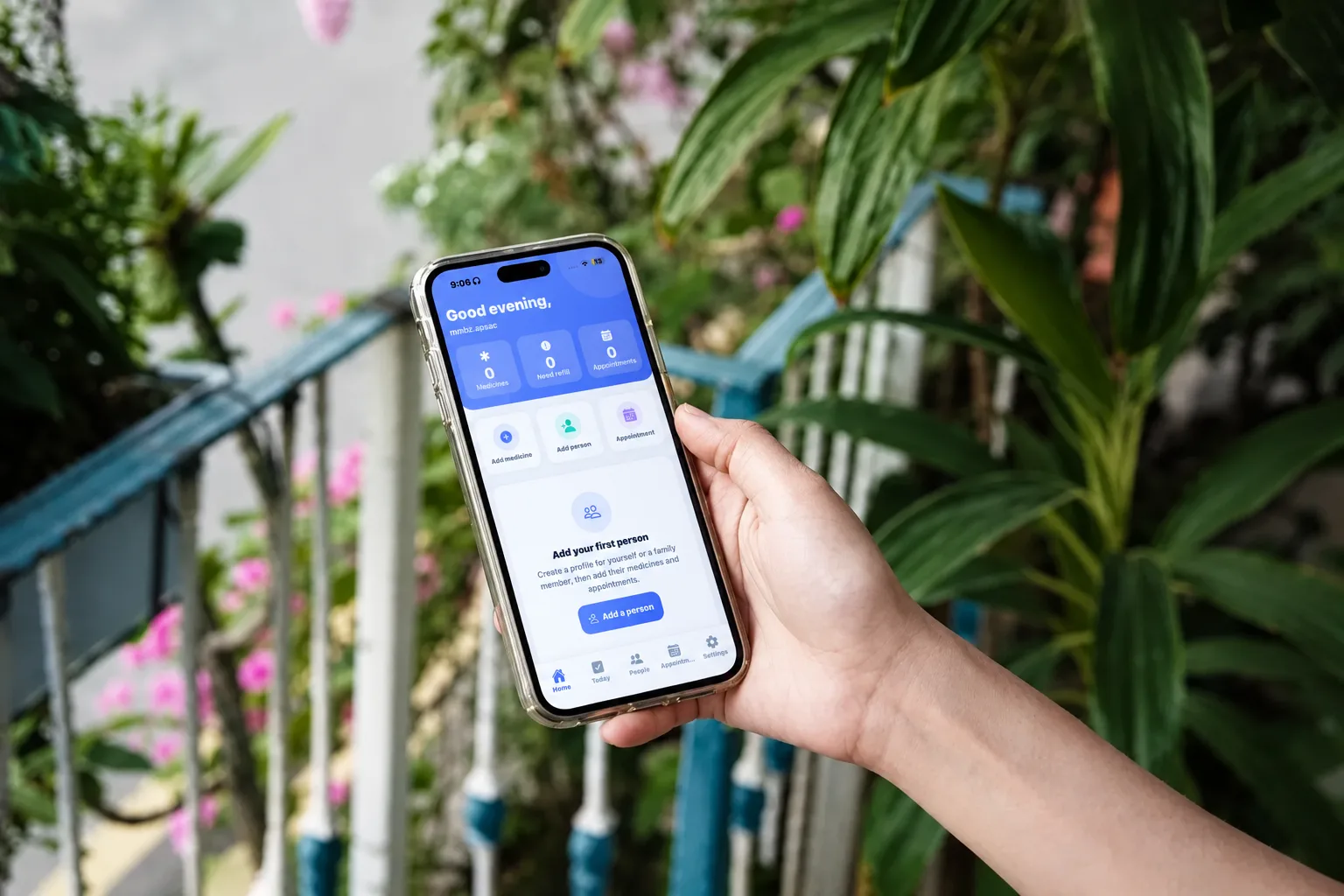 Hand holding a smartphone displaying a mobile app interface outdoors
